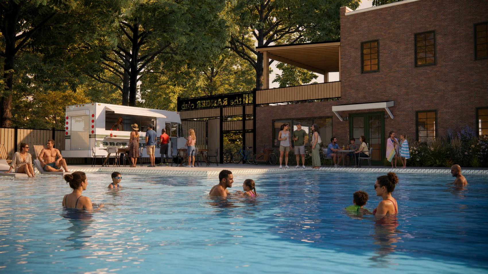 Families in the pool at dusk, with a food truck at the gate and the windows lit behind