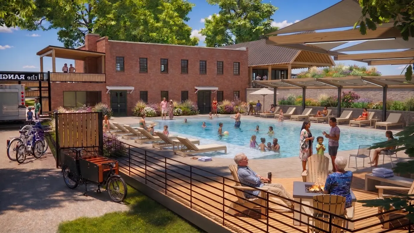 The pool on a summer day, with a shallow sun shelf, shade sails, loungers and a fire pit corner